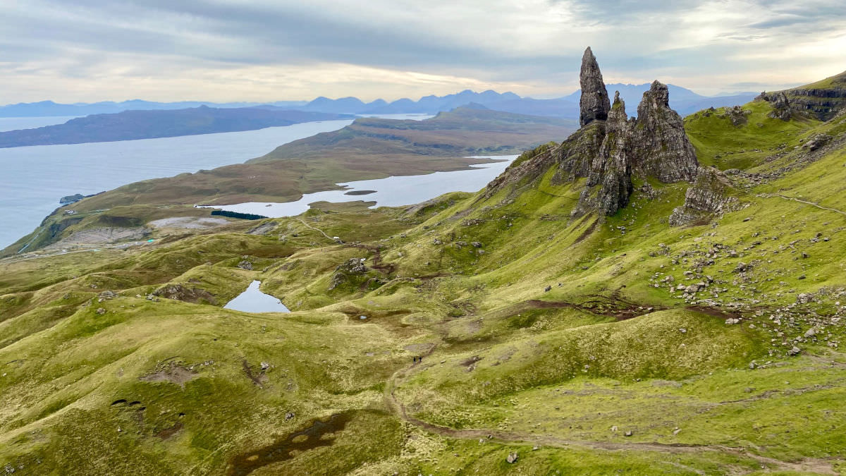 Grassy mountainous region with views of water in Isle of Skye