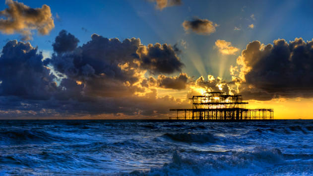 Sun setting behind the old pier in Brighton