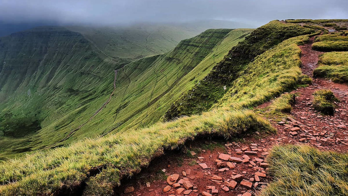 Verdant mountain with clay path in the UK