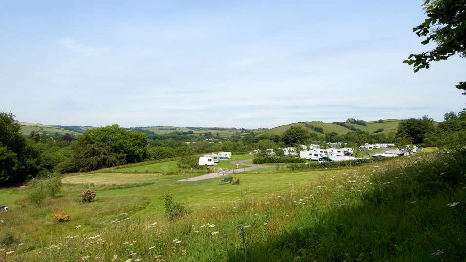 Exebridge Lakeside club site view from the hillside of the caravan and motorhome pitches
