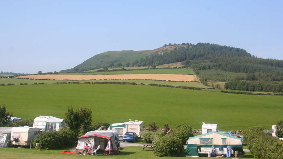 The Ranch club site caravan pitches with the hills in the background